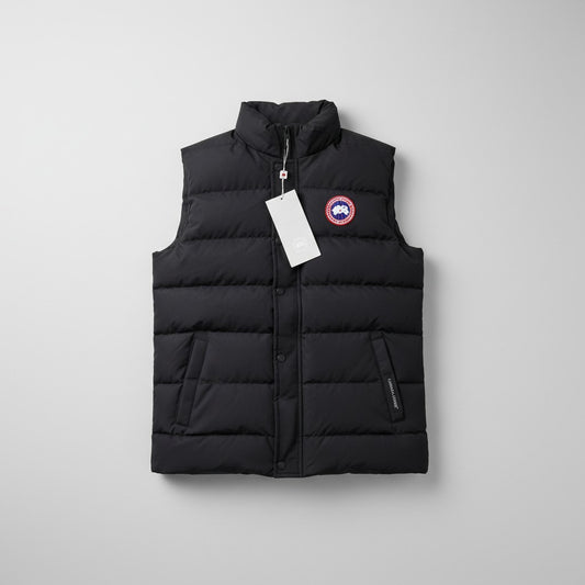 Butik X Moda black puffer vest with Canada Goose logo patch and zip closure. Features a stand-up collar and side pockets.